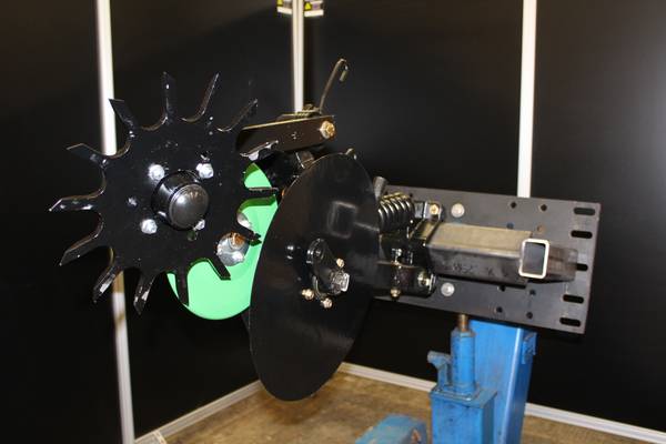 Remanufactured row unit with new 13-inch Martin spiked closing wheel installed