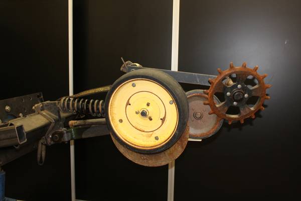 Worn John Deere 750 row unit before remanufacturing showing wear and damage